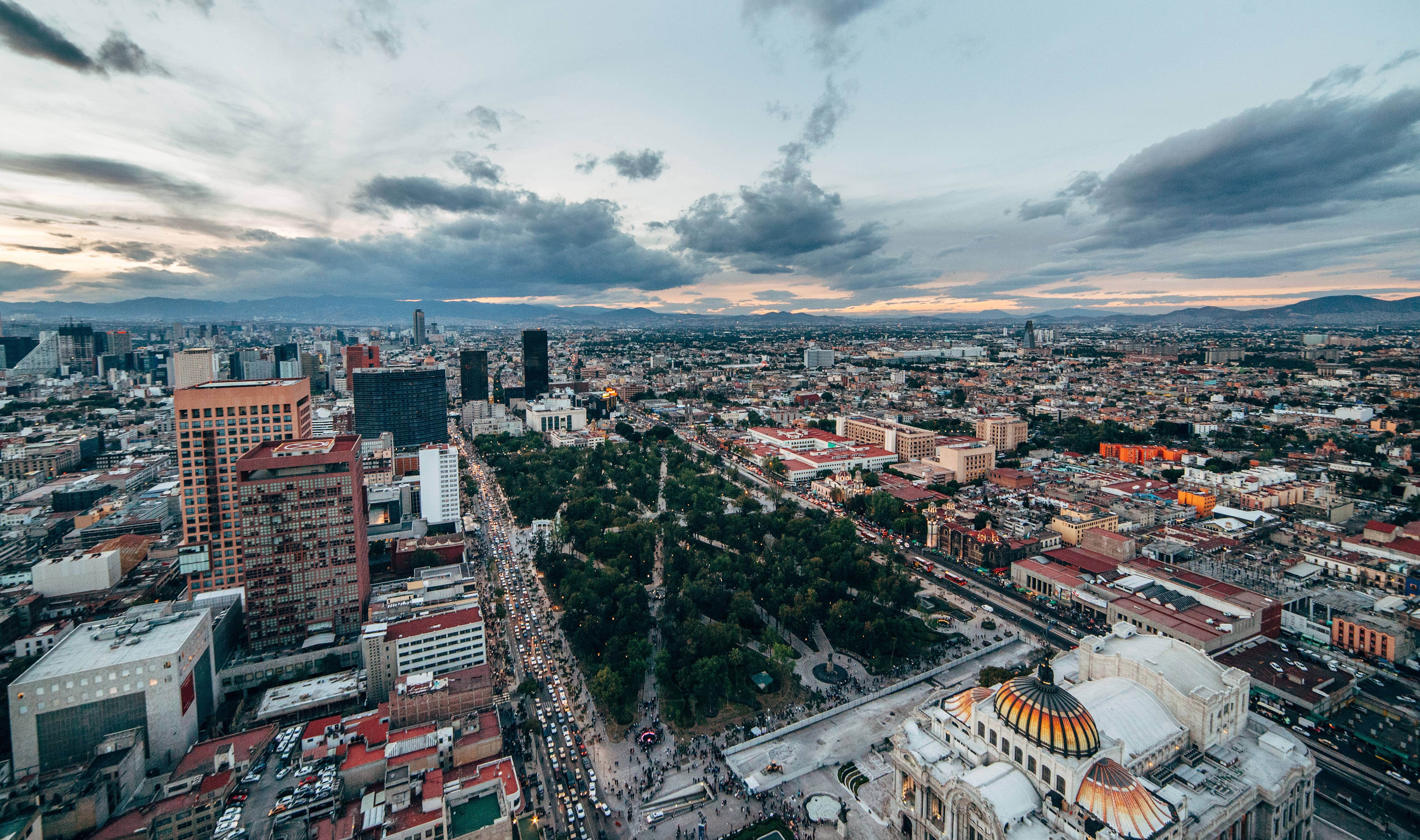 Travel to Mexico City - View of the green park Alameda Central in the center of Mexico City, surrounded by buildings